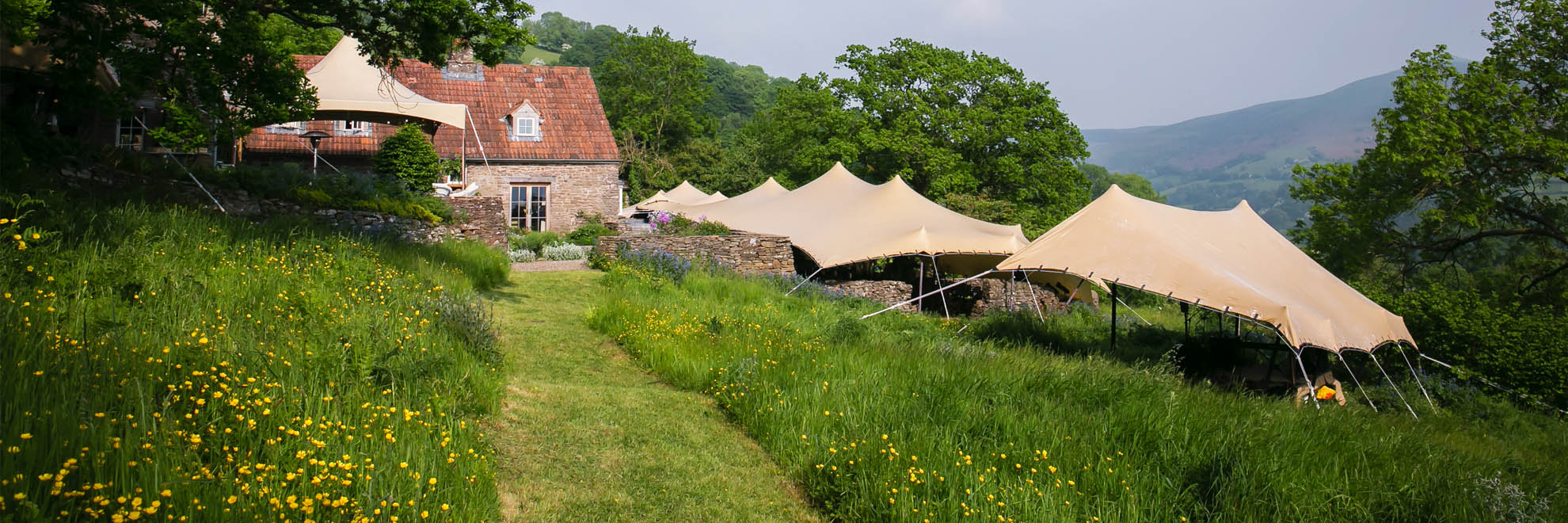 Biege stretch tent next to meadow