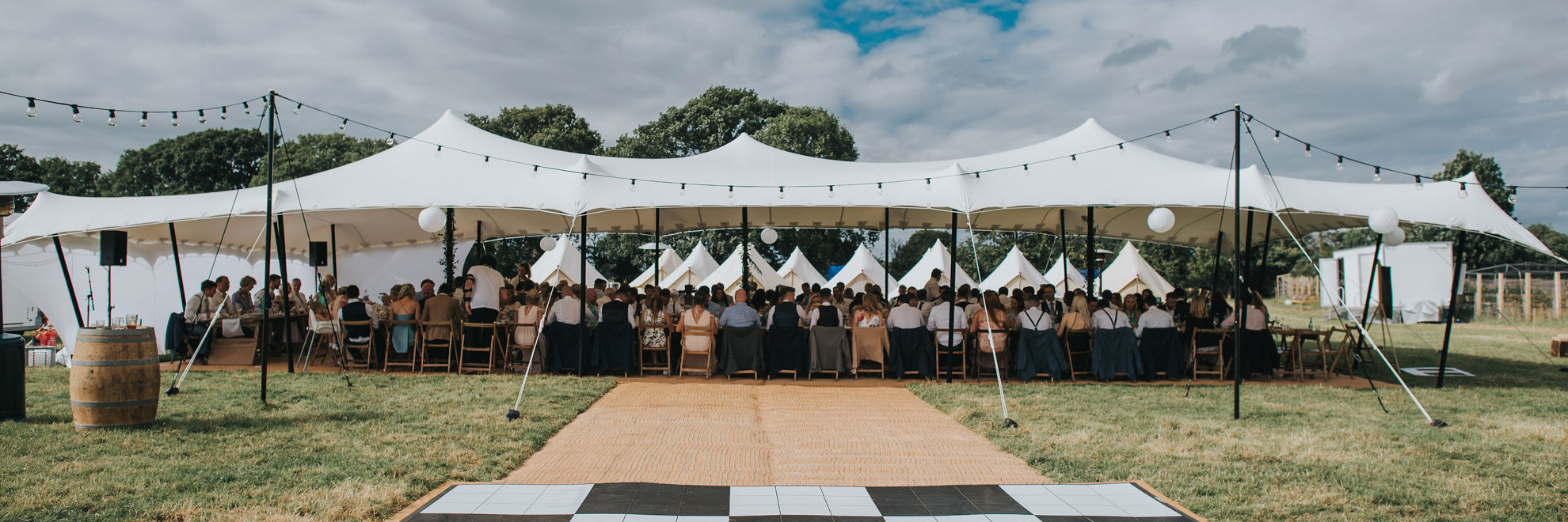 Large white stretch tent guests seated