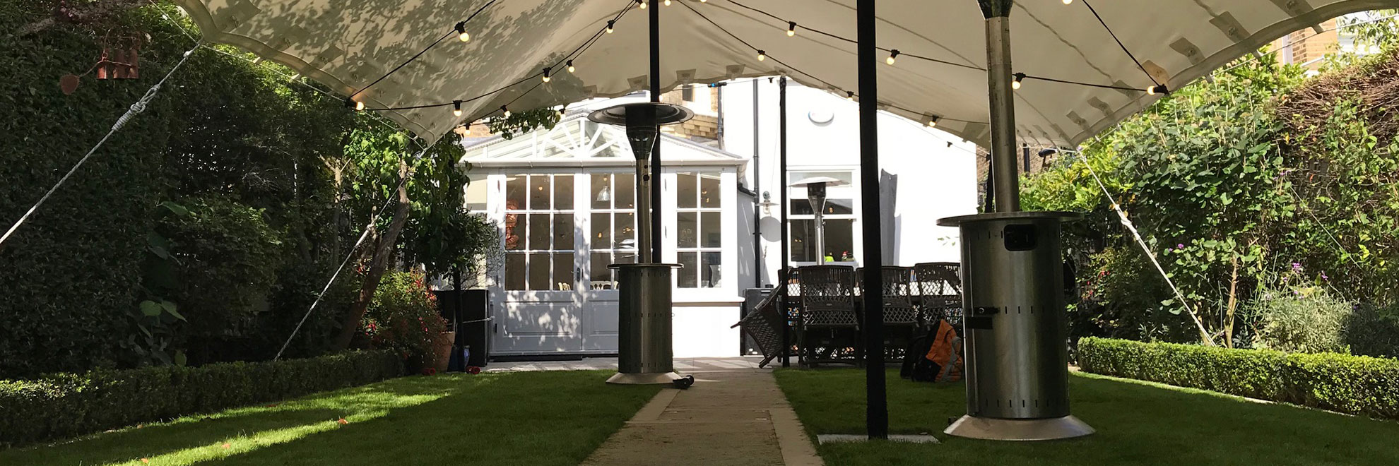 White stretch tent over garden patio heater