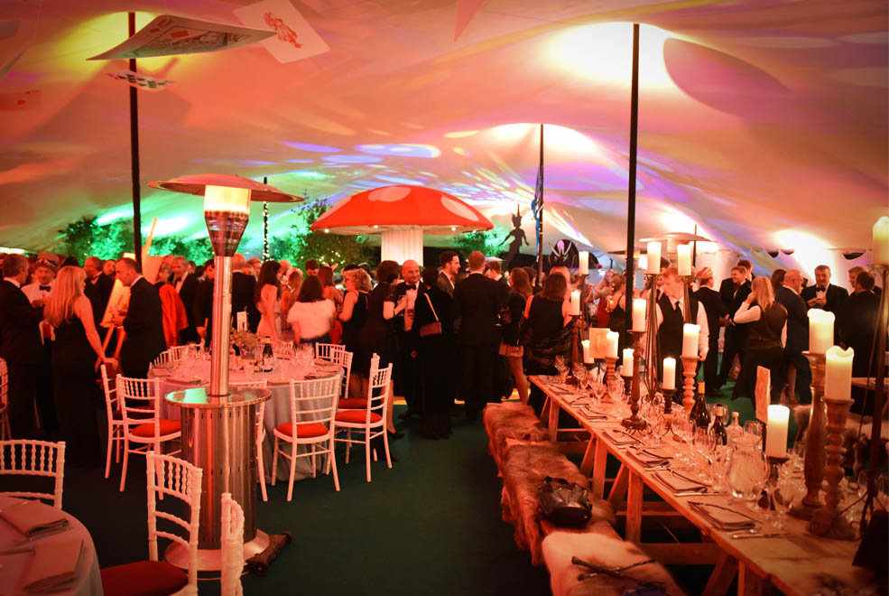 white stretch tent with giant red mushroom in it.