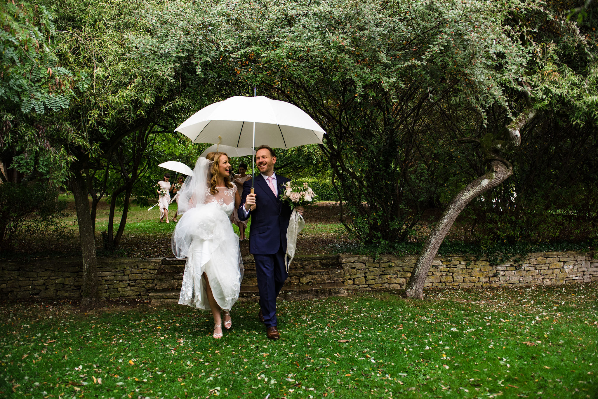 Bridal couple under umbrella